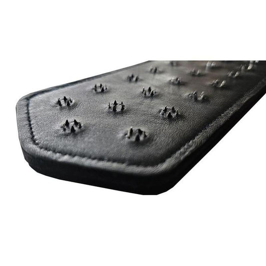 Black leather paddle with metal spikes for intense impact play, durable real leather