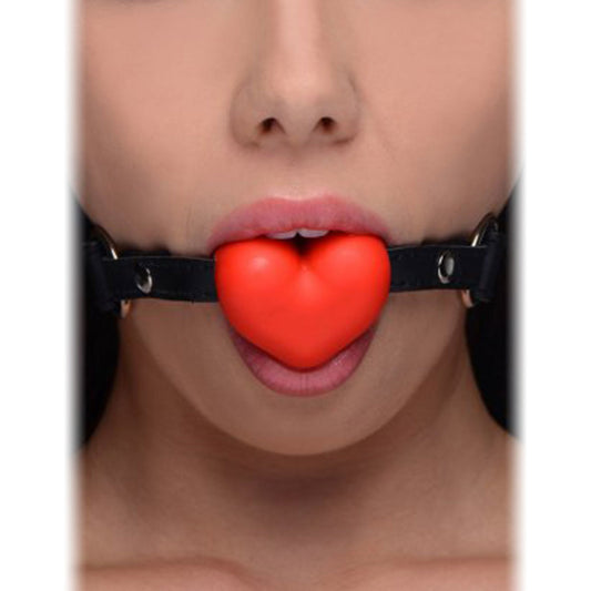 Frisky Heart Beat Silicone Heart Shaped Mouth Gag in red, featuring an adjustable strap and soft silicone heart for playful restraint.